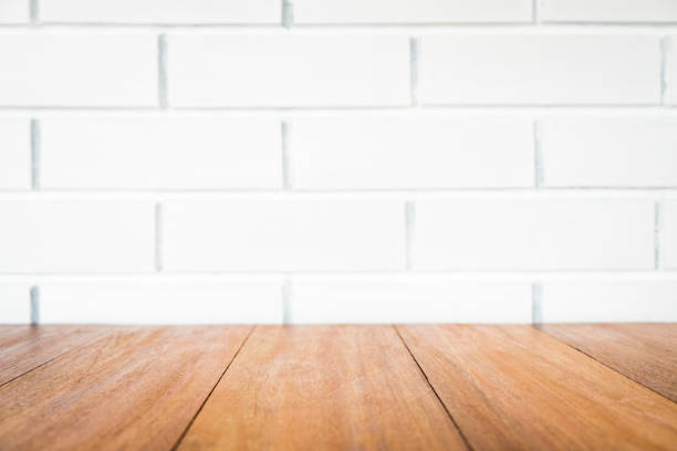 istock Wood table in front of white brick wall background 1363237842
