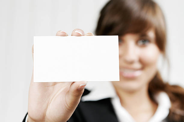 istock Smiling woman holding blank business card 136324558