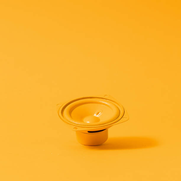 istock Subwoofer or speaker on yellow background, monochrome still life 1363247271