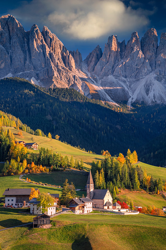 Beautiful St. Magdalena village with magical Dolomites mountains in a gorgeous Val di Funes valley,  South Tyrol, Italian Alps at autumn sunset.