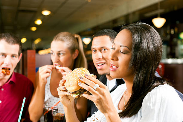 istock Friends eating fast food in a restaurant 136325327