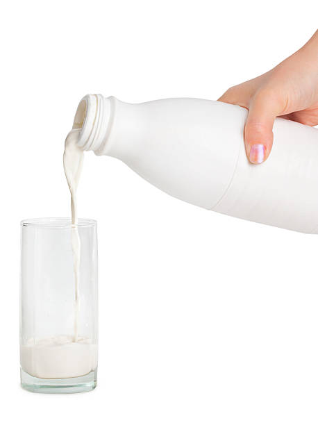 istock Hand with milk bottle and glass 136325343