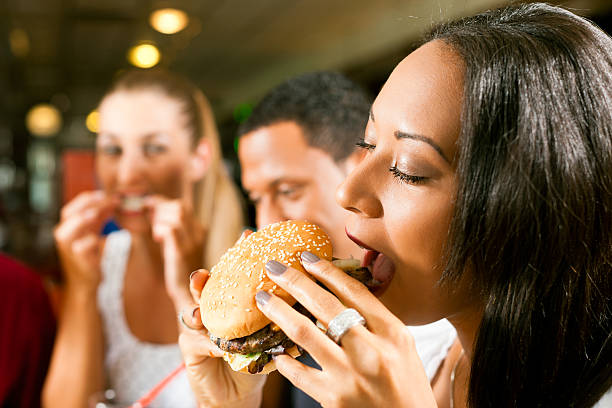 istock Friends eating fast food in a restaurant 136325390