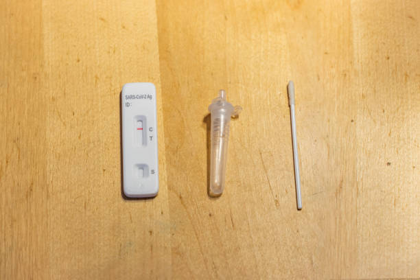 istock Negative Covid-19 test with one red line on the cassette, an extraction buffer tube and a disposable swab 1363254963