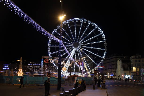 The ferris wheel illuminated at night near the old port, city of Marseille, department of Bouches du Rhône, France