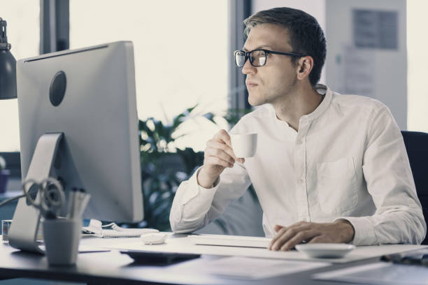 istock Businessman drinking coffee and smiling 1363257149
