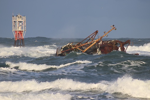 Shipwrecked boat in sea o