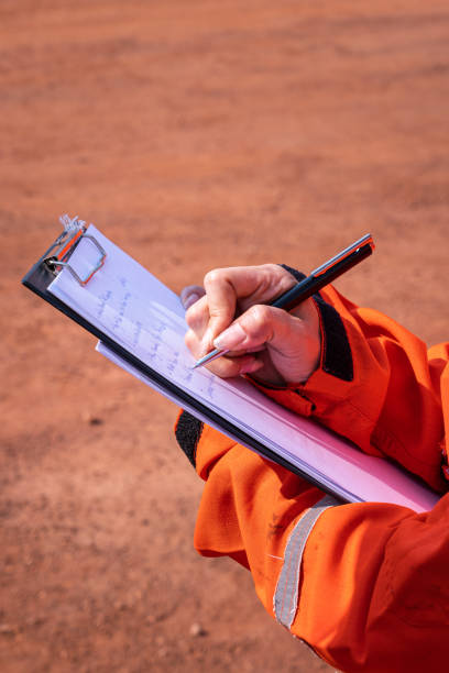 istock Writing note on paper - Audit and inspection in oil field operation. 1363263080