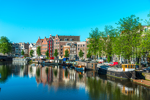 Spring in Amsterdam, Waalseilandgracht, early morning, under a blue sky, sunny day.