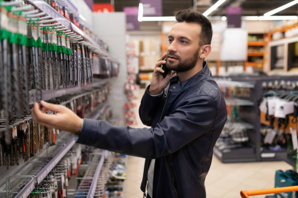 istock customer man in a hardware store chooses drills for a drill and screwdriver 1363264897