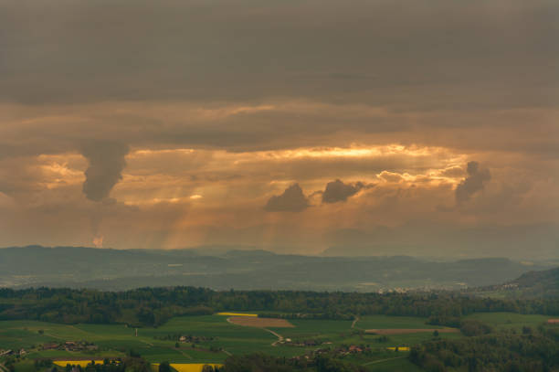 istock Close-up of sun rays bursting through clouds 1363265970