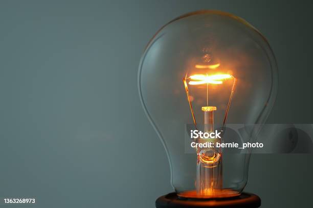 Close Up Glowing Light Bulb Stock Photo - Download Image Now - Light Bulb, Illuminated, Electric Lamp