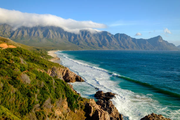 The beautiful scenic Clarence Drive between Gordons Bay and Rooi-Els About 20kms of twists and turns beneath the Hottentots Hollands mountains with views of the wild turquoise Cape coastline gordons bay stock pictures, royalty-free photos & images