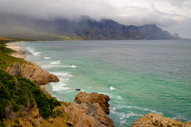 The beautiful scenic Clarens Drive between Gordons Bay and Rooi-Els About 20kms of twists and turns beneath the Hottentots Hollands mountains with views of the wild turquoise Cape coastline gordons bay stock pictures, royalty-free photos & images