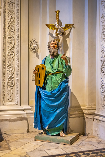 Old wooden sculpture of Moses in the Theatine Church Theatinerkirche from 1690 which is built in an Italian High-Baroque style. It is one of the many churches in the German city Munich (the capital city in Bavaria) which has been damaged during Second World War but has been rebuild afterwards.