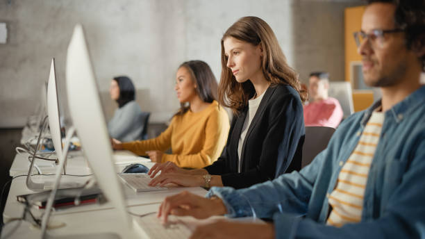 istock Beautiful Smart Female Student, Studying in Modern University with Diverse Multiethnic Classmates. College Scholars Work in College Room, Learning IT, Programming or Computer Science. 1363276359