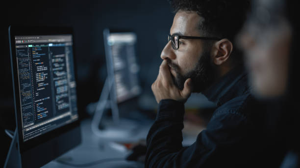 istock Handsome Smart Male Student, Studying in University with Diverse Multiethnic Classmates. He Works on Desktop Computer in College. Applying His Knowledge in Writing Code, Developing Software. 1363276611