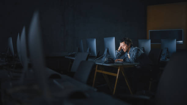 istock Stressed Male Student Sitting Alone in College Informatics Room, Working Late Evenings on Computer Science Project. Tired Scholar Study IT on Computer in University, Writing Homework. 1363276616
