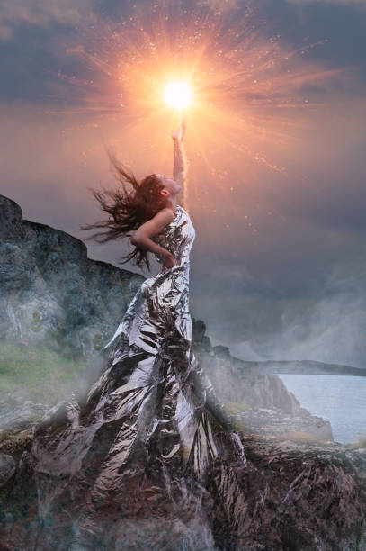 An artistic photo of a girl dressed in a foil dress An artistic photo of a fantasy young woman dressed in a foil dress lighting the sun in the mountains"n goddess stock pictures, royalty-free photos & images