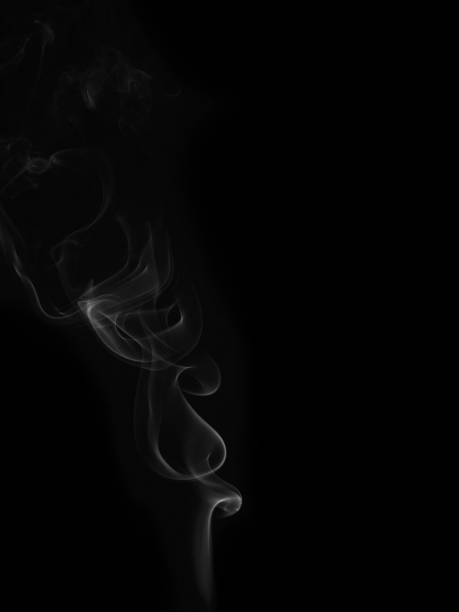 istock wax candle with burning wick and smoke, isolated on a black background 1363277645