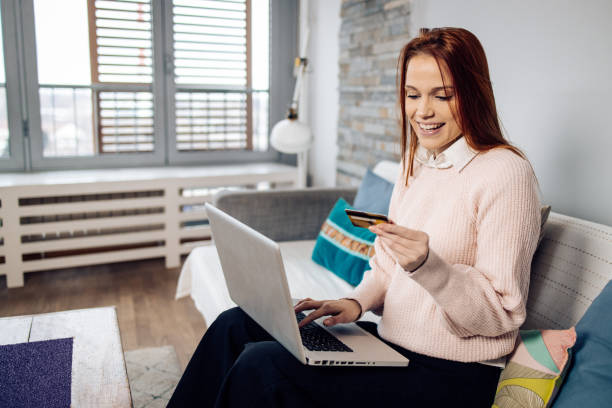 istock Redhead young woman making an online payment 1363277850