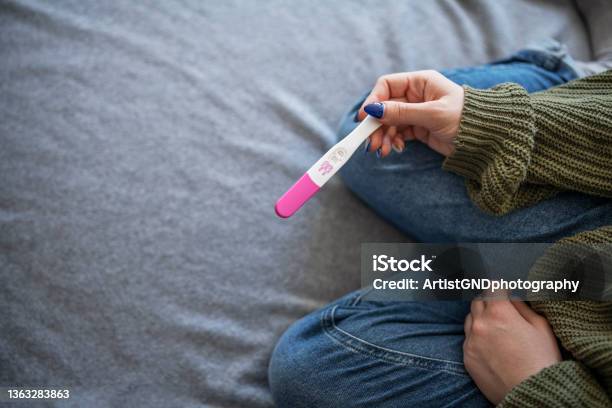 Woman Holding Positive Pregnancy Test Stock Photo - Download Image Now - Pregnancy Test, Infertility, Ovulation