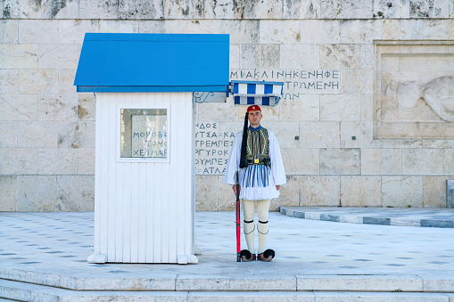 Athens, Greece - April 22, 2018: The Tomb of the Unknown Soldier is a war memorial located in Syntagma Square in Athens, in front of the Old Royal Palace. It is a cenotaph dedicated to the Greek soldiers killed during war. It was sculpted between 1930 and 1932 by sculptor Fokion Rok. The tomb is guarded by the Evzones of the Presidential Guard