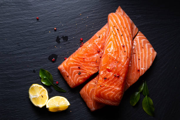 istock Food concept Uncook fresh salmon on black slate stone board with copy space 1363288471