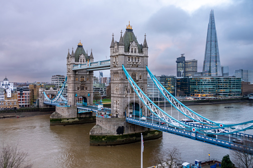 The Tower Bridge northern approach. It is on a grey winters day with traffic on the bridge in London, England, UK.