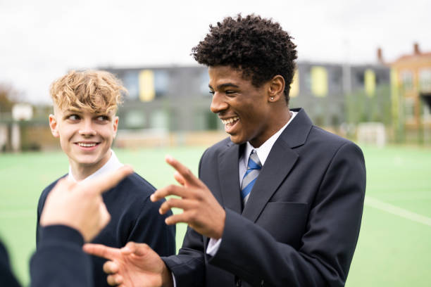 candid outdoor portrait of playful schoolboys on campus - adolescence teenager high school student teenagers only imagens e fotografias de stock