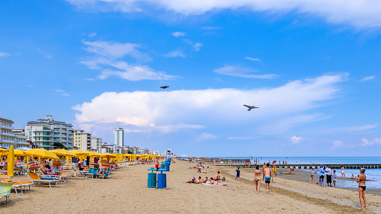 People relaxing at the beach of Jesolo Lido, one of the main destinations of summer tourism on the Adriatic riviera of Veneto.
