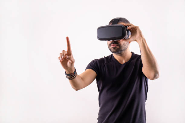 istock Young man in VR glasses headset gesturing portrait. Virtual reality, future technology, education video gaming 1363292478
