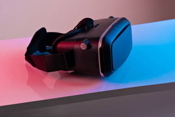 istock Black VR glasses mask on neon color background. Virtual reality headset 1363292680