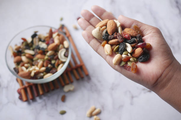 istock top v view of mixed nut on hand 1363297833