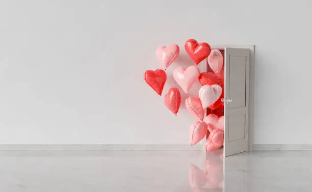 Photo of room with open door and heart shaped balloons entering