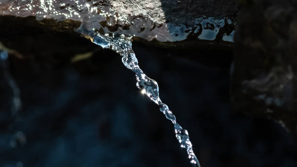 istock Bright Glint of Sunlight Reflecting from a Thin Stream of Water 1363299332