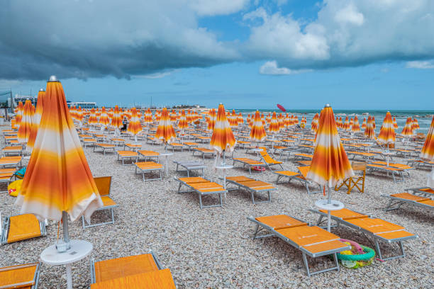 the colored beach of Fano before a thunderstorm Fano, Italy - 07-08-2021: the colored beach of Fano before a thunderstorm marche italy stock pictures, royalty-free photos & images