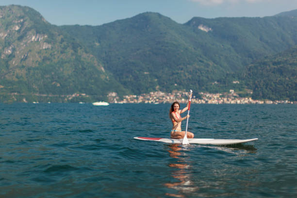 istock Young woman paddling on a stand up paddle board 1363301134