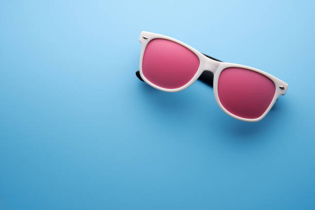 white frame sunglasses  with pink color tinted against blue background