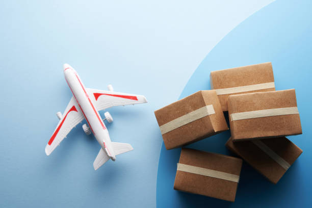 istock toy airplane and brown cardboard box  on blue background 1363304177