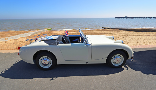 Felixstowe, Suffolk, England -  May 06, 2018: Classic White Austin Healey Sprite Motor Car Parked on Seafront Promenade.
