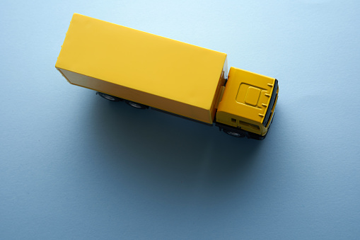 high angle view of yellow truck on blue background