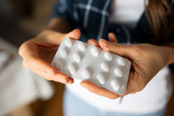 istock Woman Holding a Blister Pack With Pills 1363305033