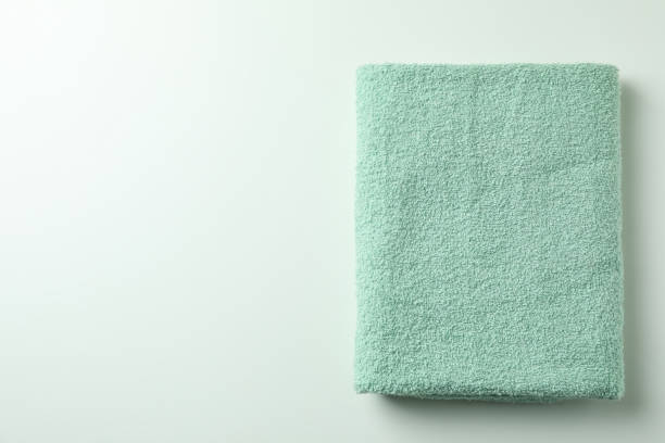 Clean green folded towel on white background