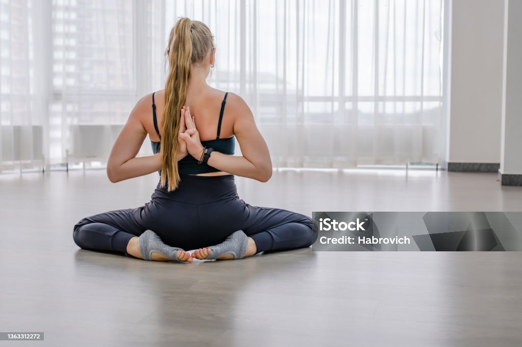 woman sit with her arms closed behind her back woman sit with her arms closed behind her back . Active Lifestyle Stock Photo