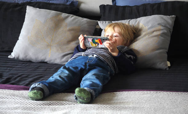istock Little boy use smartphone on a bed 1363315798