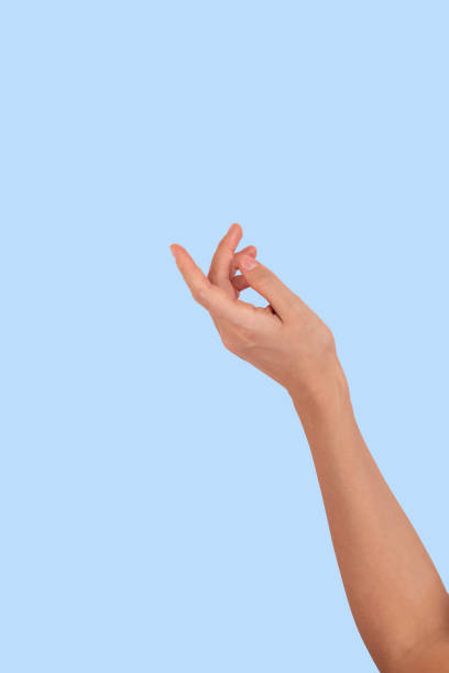 istock Woman hand against blue background 1363316991