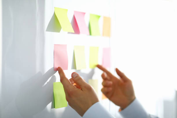 istock Close-up of worker hand holding colorful papers for notes with information 1363324806