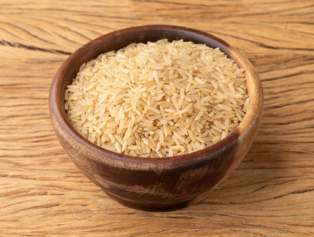 istock Raw brown whole rice in a bowl over wooden table 1363324941