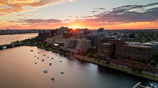 Aerial shot of Cambridge, Massachusetts at sunset on an evening in early Fall, taken from over the Charles River and looking down on offices and apartment buildings on the waterfront. 

Authorization was obtained from the FAA for this operation in restricted airspace.